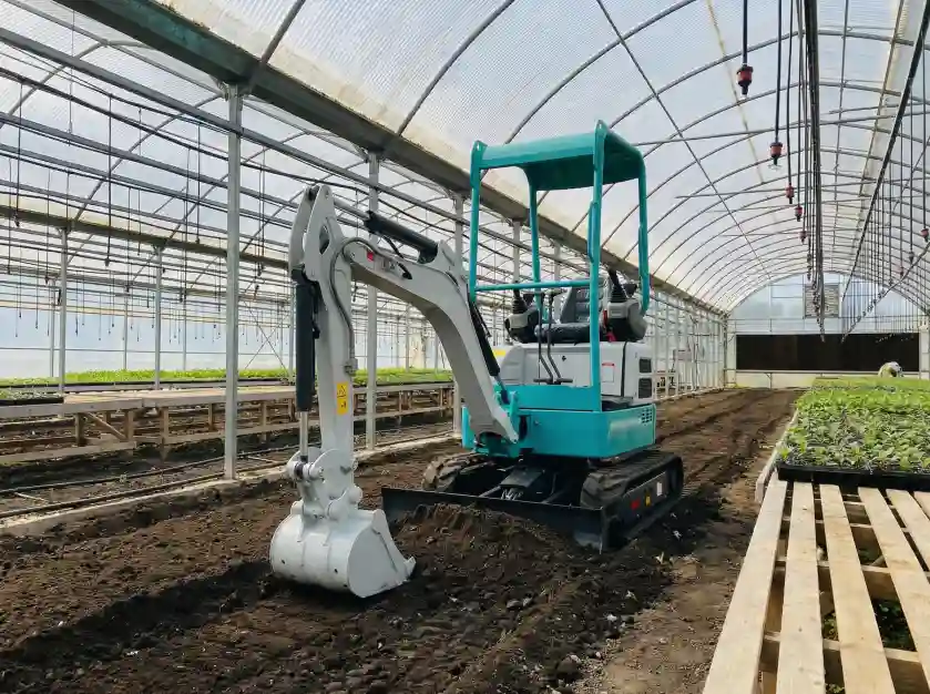 Excavator-leveling-and-preparing-soil-in-a-large-commercial-greenhouse