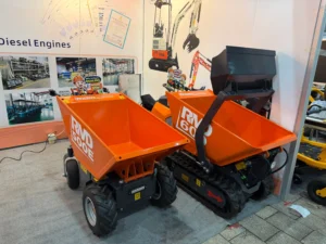 Mini dump trucks displayed at ACE Machinery booth during Canton Fair with compact construction equipment for sale